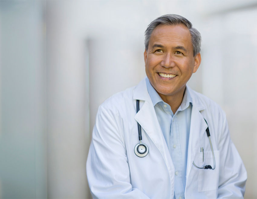 Doctor Smiling about Joint Pain Treatment Near Chesterfield, MI