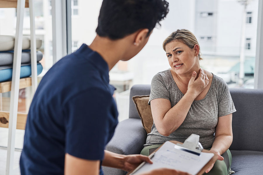 Woman with Doctor for Pain