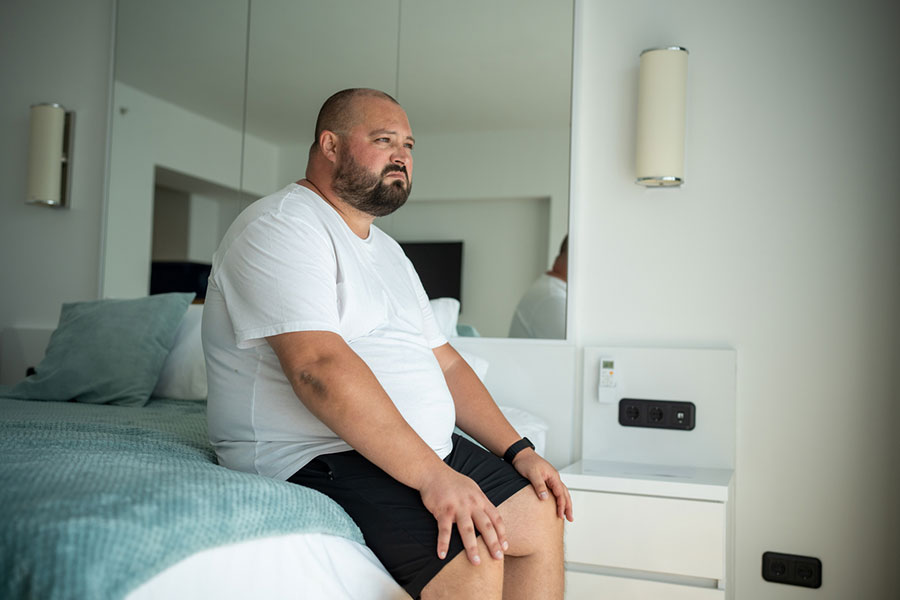 Overweight Man on Bed